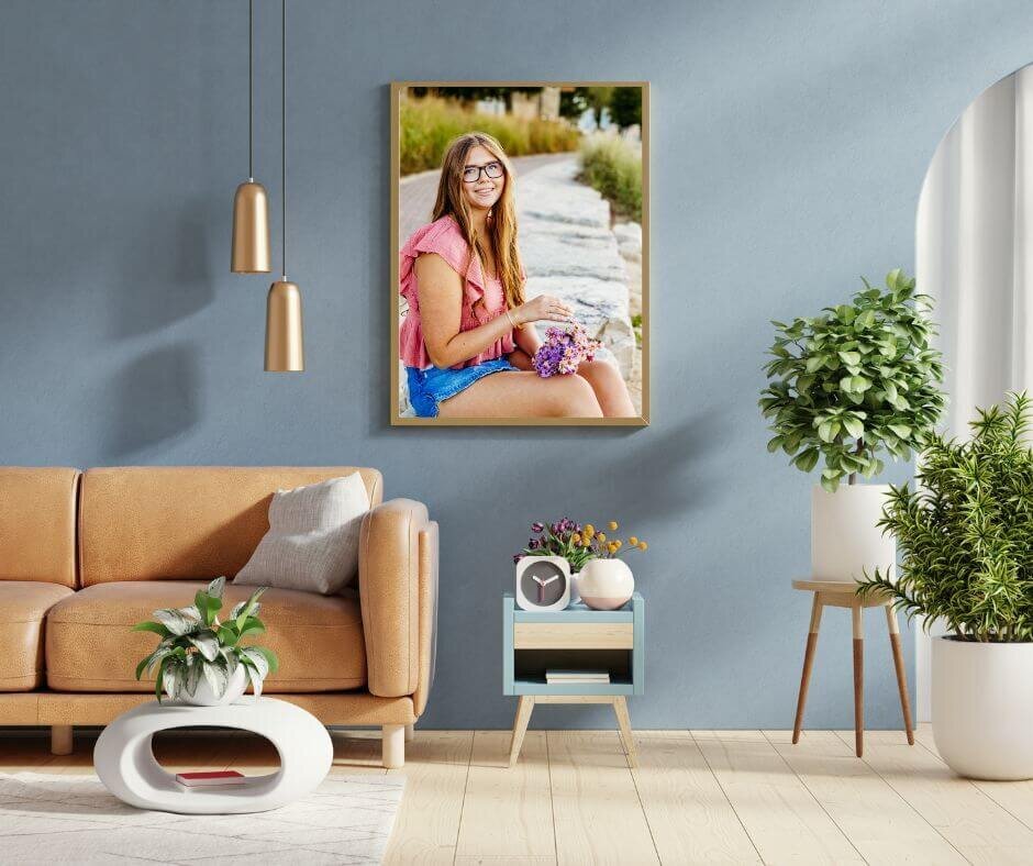 stunning framed print of an Oshkosh high school senior hanging on the blue walls by a tan colored sofa 