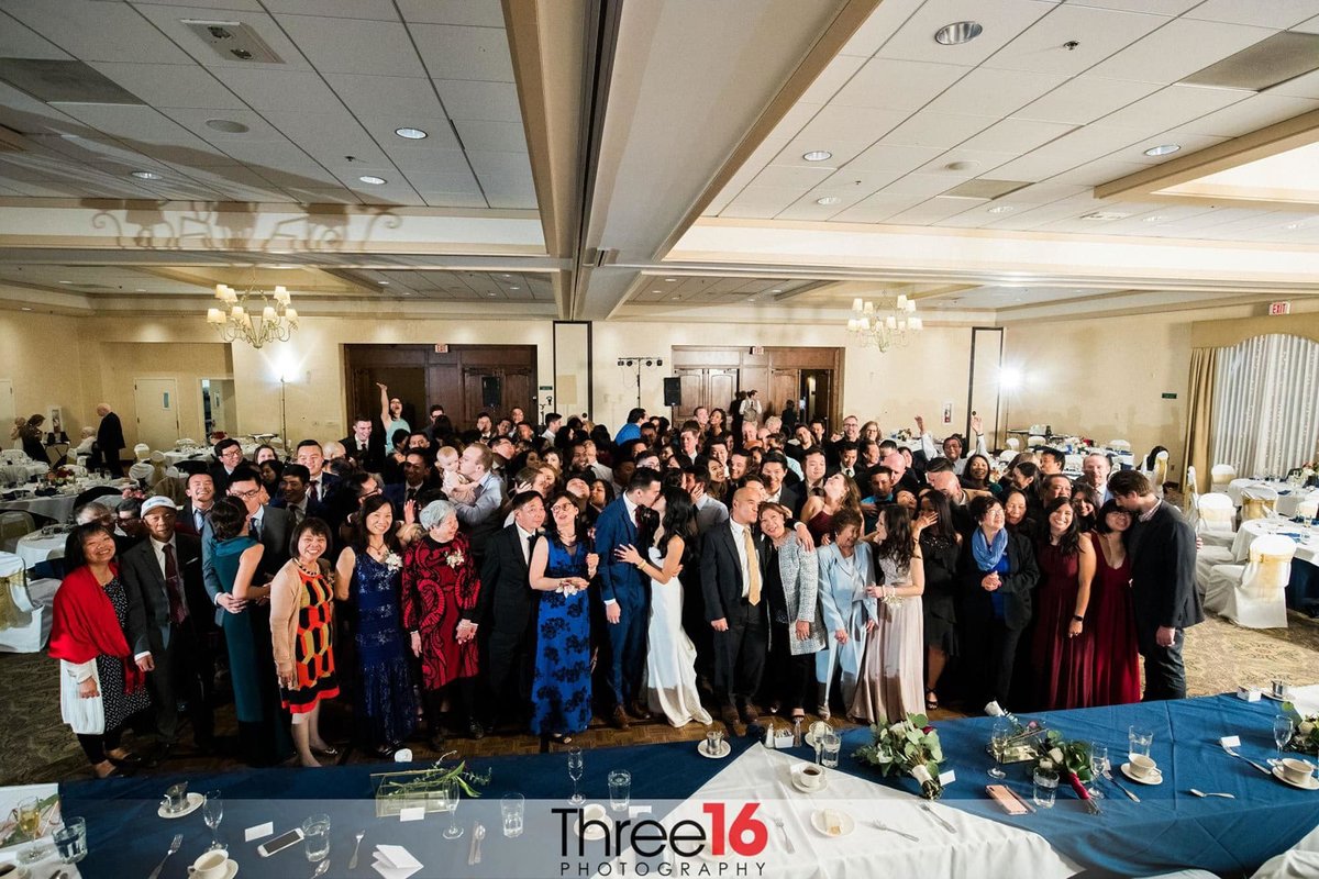 Large wedding photo of all the guests at the reception