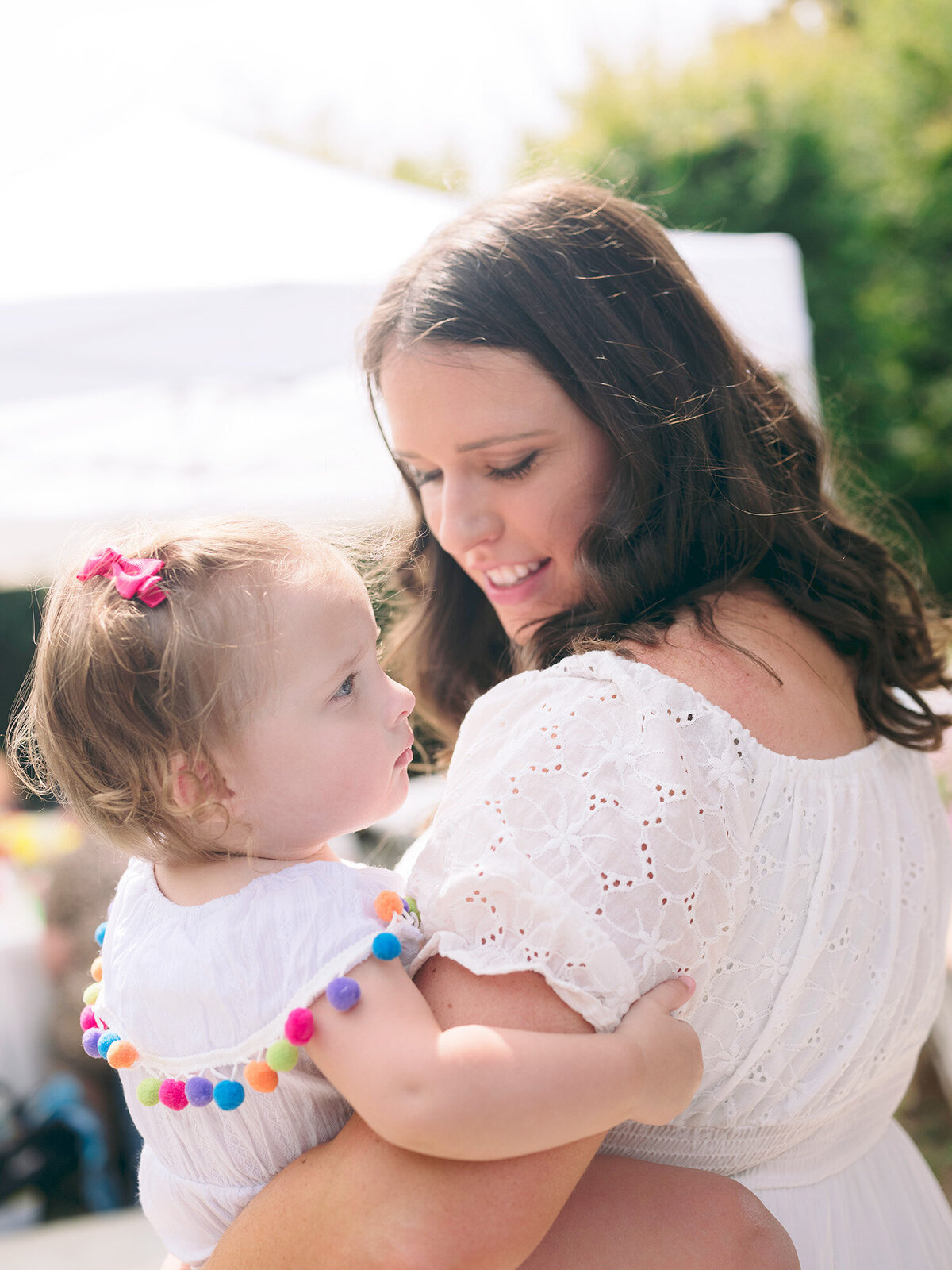 Mom snuggling her baby during a first birthday party in Novato, photographed by a Bay Area first birthday photographer.

