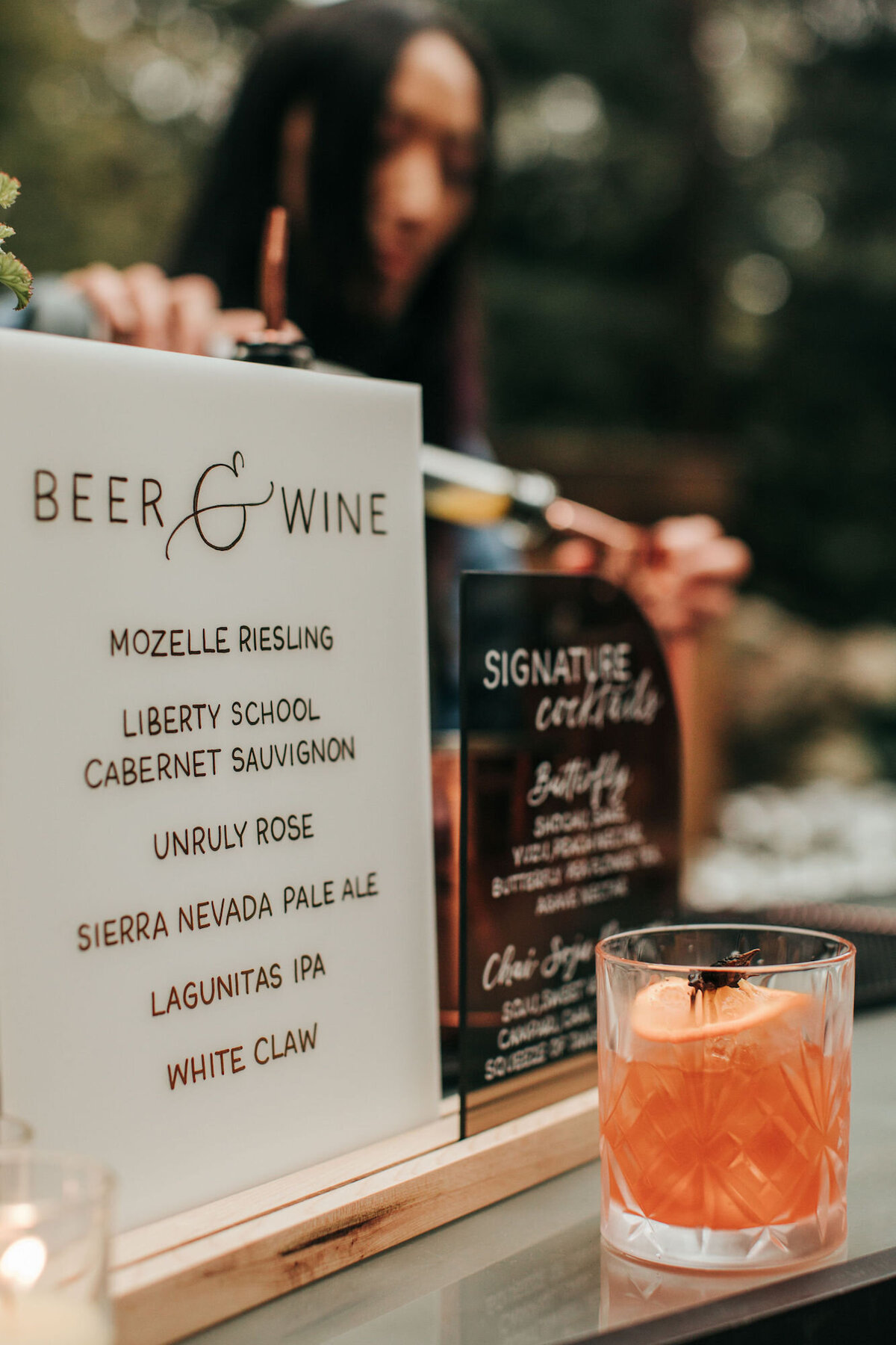 Handwritten calligraphy bar sign with drinks