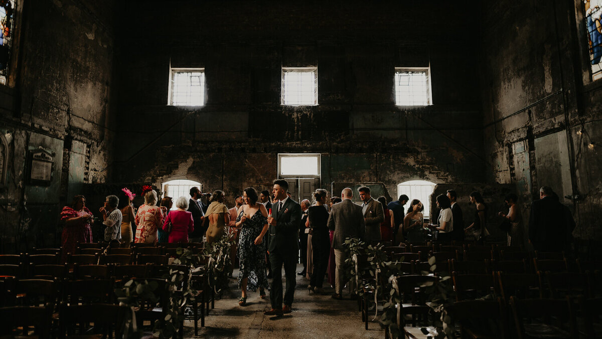 Drinks reception at The Asylum Chapel as the light comes through the windows. 