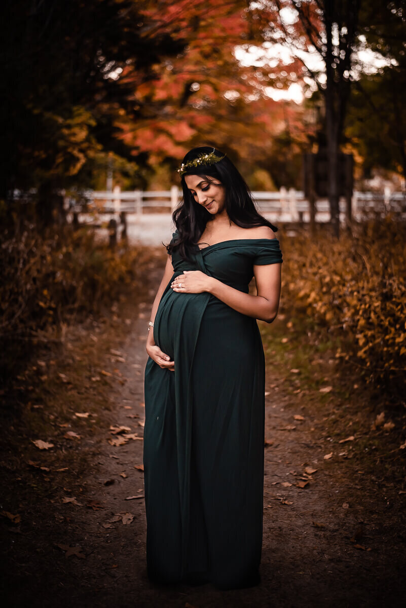 Pregnant woman loving her baby bump in Toronto Maternity Photos