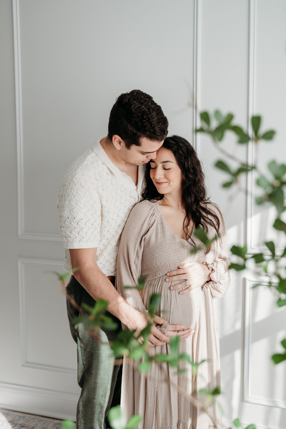 Mom and Dad sharing the love during a maternity photoshoot in the studio in Bartlett, IL