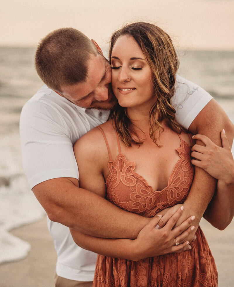 These family photos by the beach captured a timeless moment where a couple embraced each other on Isle of Palms beach, proving Stephanie Selby is one of the best family photographers Charleston South Carolina has to offer