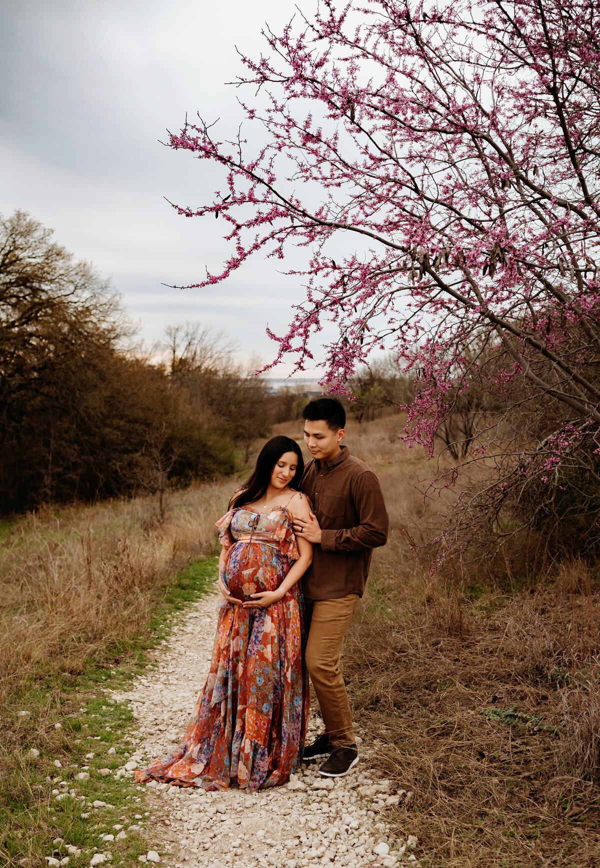 Spring is the perfect time to capture the beauty of the trees that are showing off their beautiful flowers-this beautiful couple is enjoying a nice spring day in a local park in Lake Worth, Texas with Paula Gofoth Photography