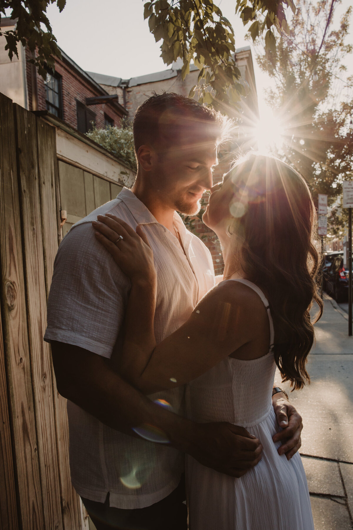 A couple with their arms around each other about to kiss 