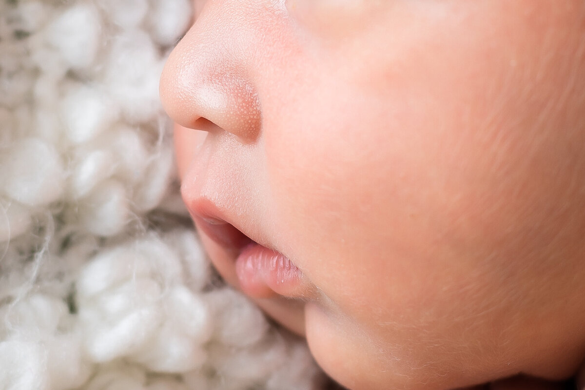 Newborn Photographer, a baby's cheek lay on a wool knit blanket