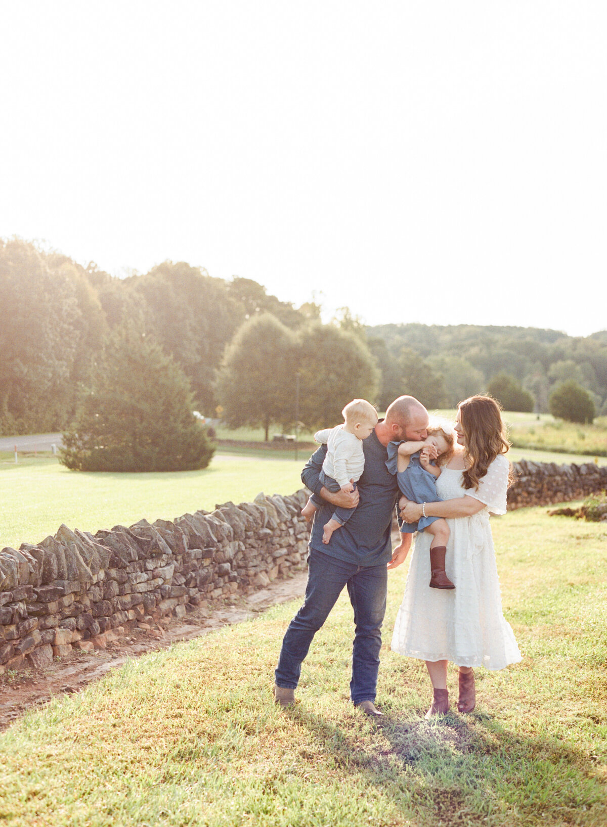 Family smiles and plays during their Wake Forest session. Image by Raleigh maternity photographer A.J. Dunlap Photography.