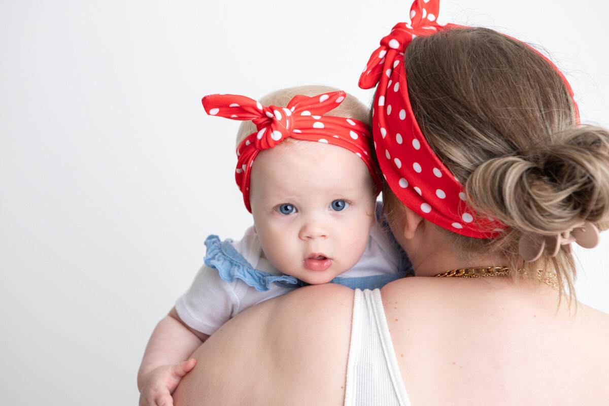 Mom and daughter studio pose with white backdrop