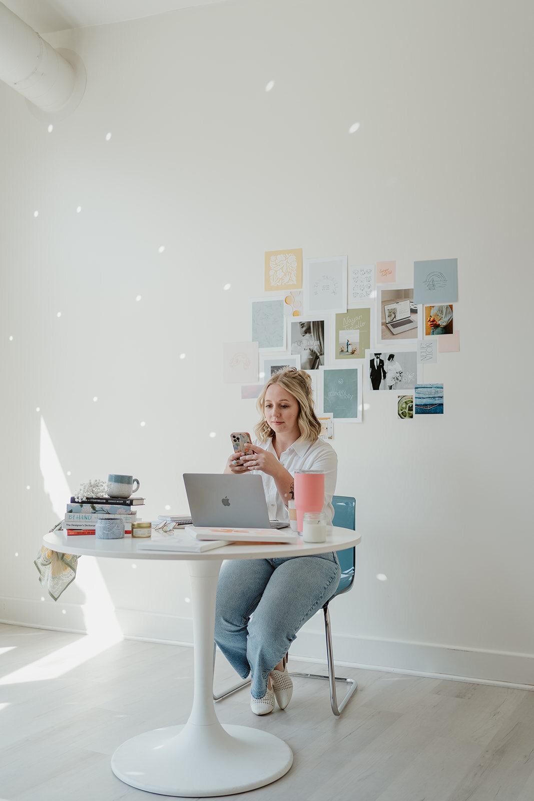 Bright studio workspace with laptop, drinks, and notebooks during a Wildher and Co branding session in Kalamazoo Michigan.