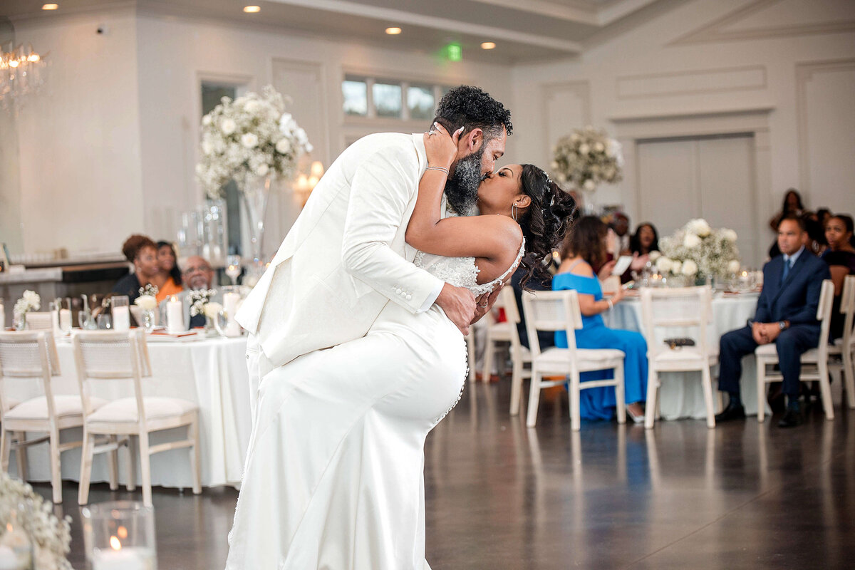 A passionate moment as the couple embraces during their first dance.