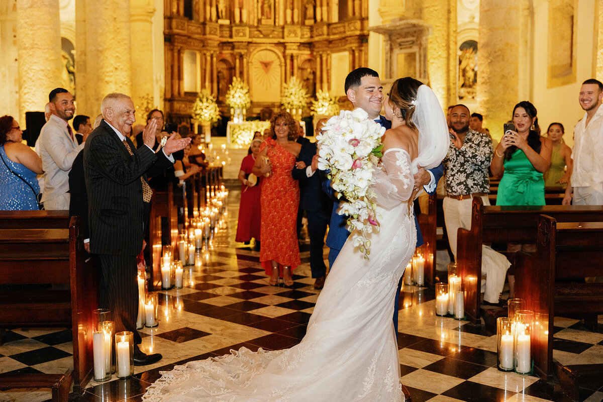 A heartfelt moment as Victoria and Daniel share their first kiss as husband and wife inside a grand Cartagena Colombia church.