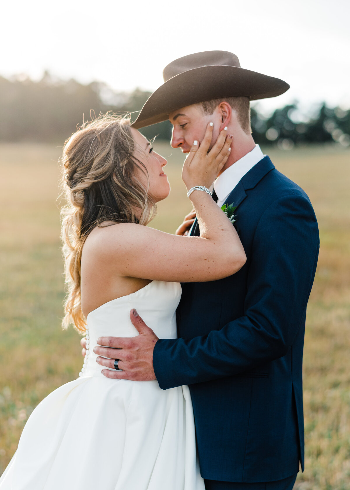 Bride and Groom in Field by Colorado Springs Wedding Photographer