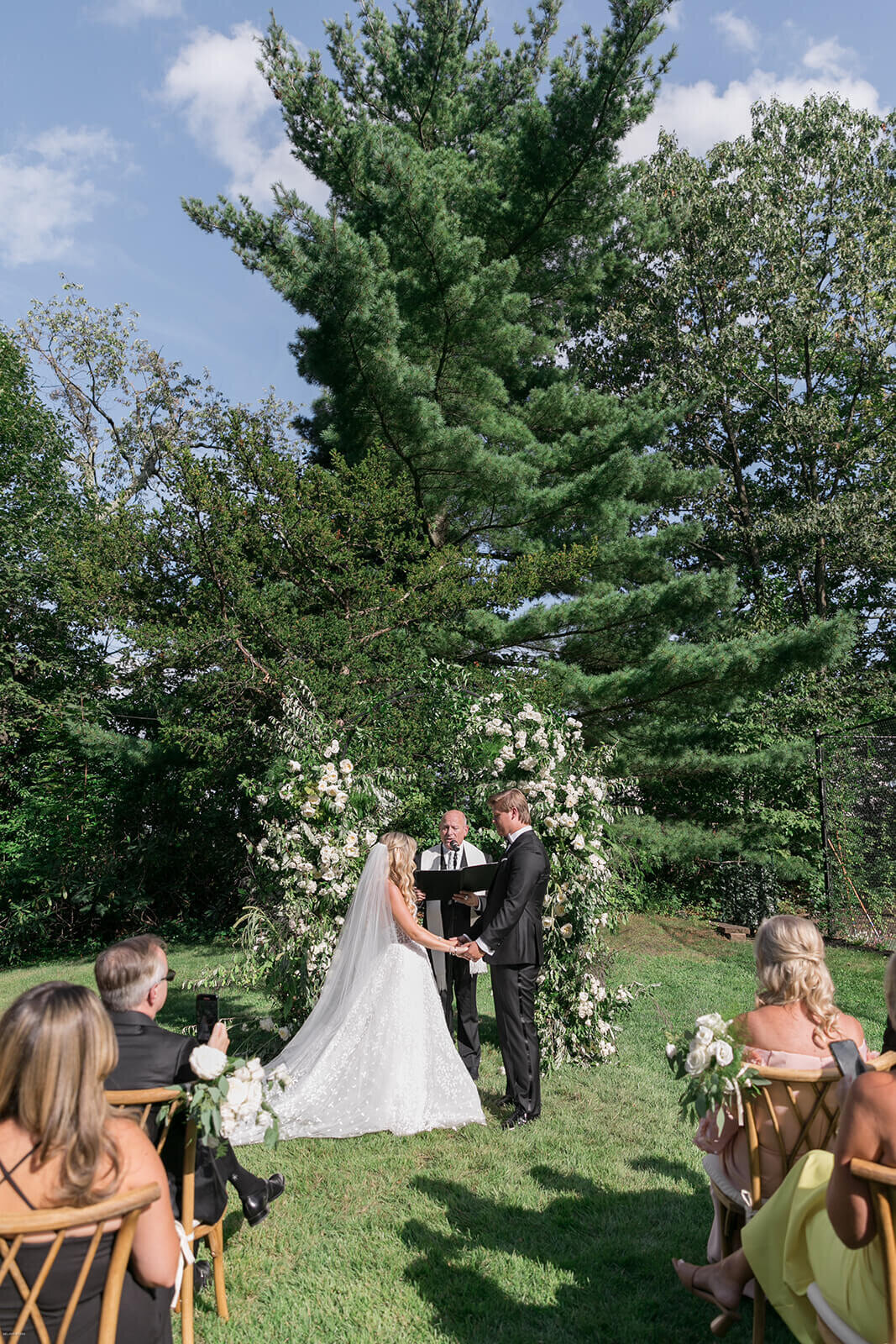 Bride and groom exchanging vows at Long Island wedding ceremony