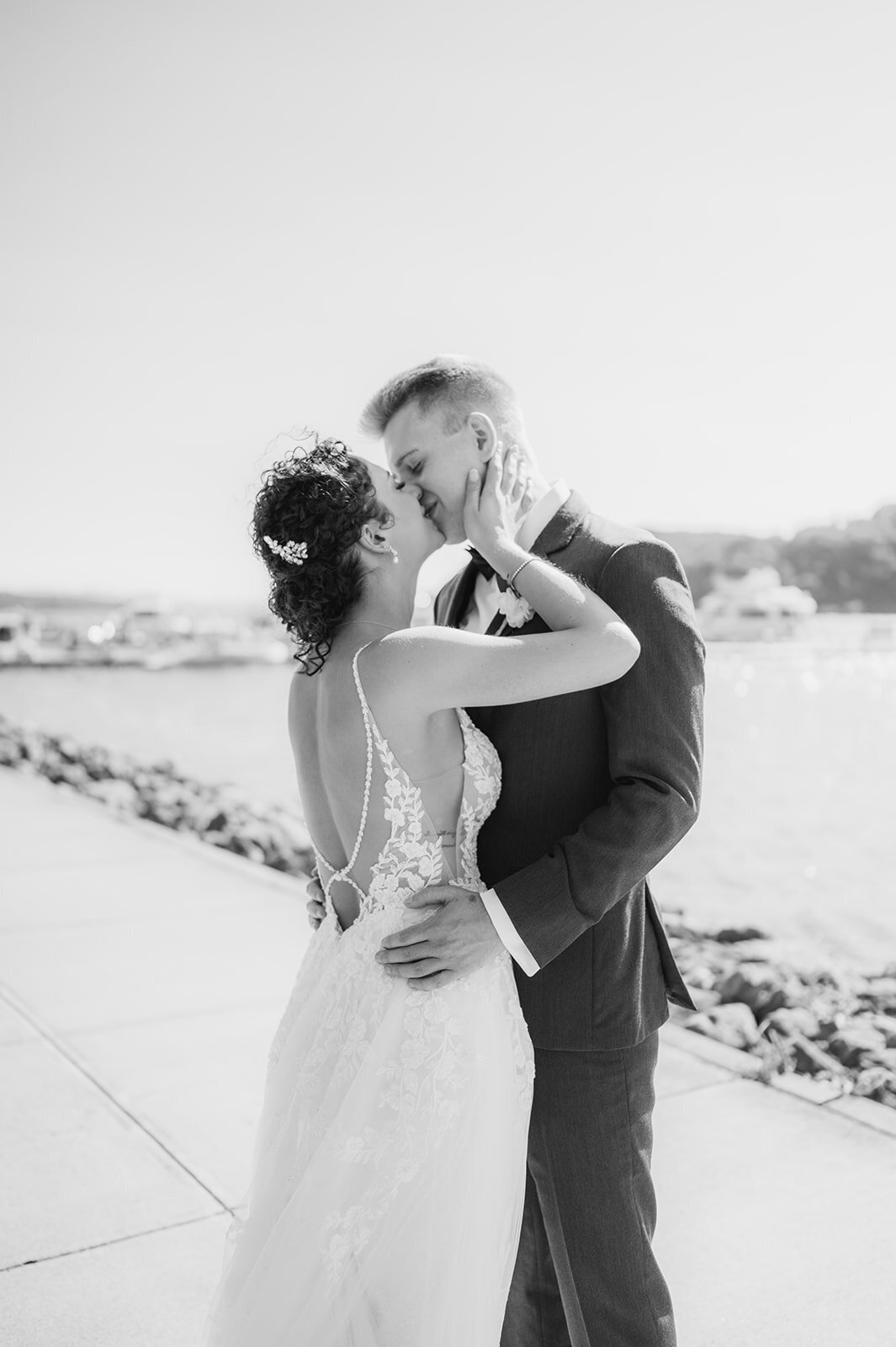 couple shares sweet embrace and kiss at summer grandview wedding in poughkeepsie