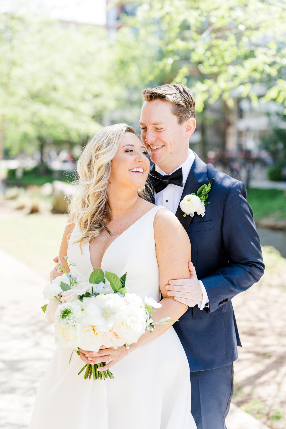 Bride and groom smiling in Falls Park at their downtown greenville wedding