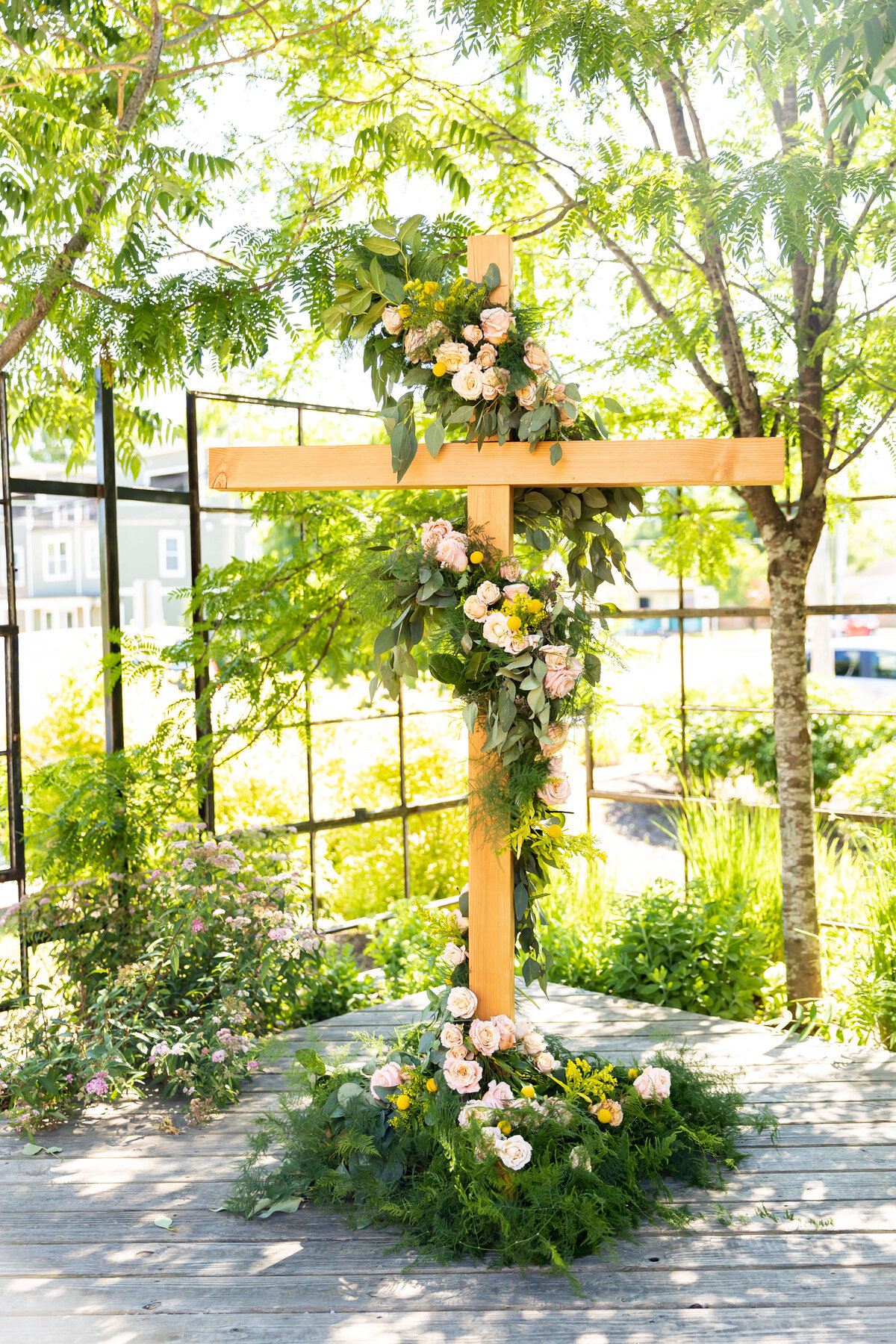 Wedding ceremony cross decorated with florals at Fat Bottom Brewery wedding in Nashville, TN