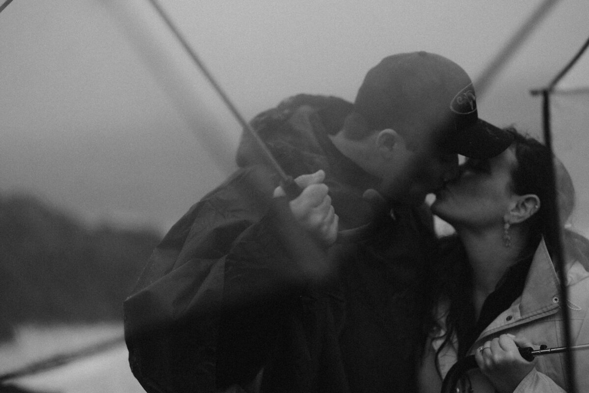 black and white image bride and groom kissing