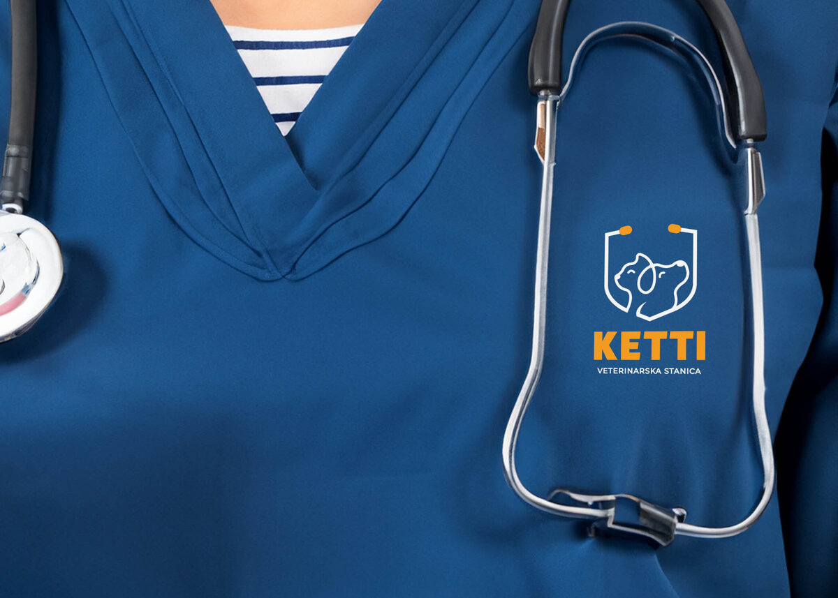 Ketti logo on dark blue scrubs