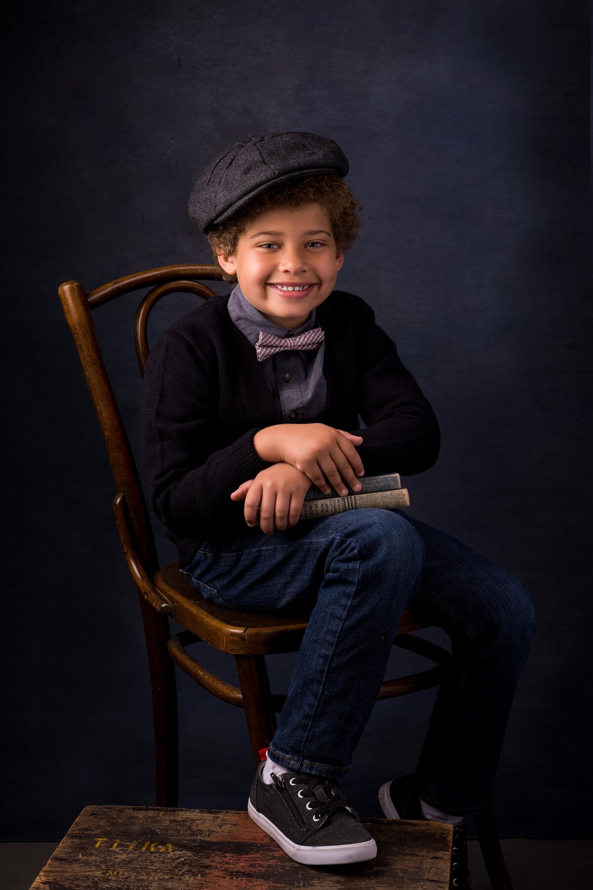 Young boy with cap sitting