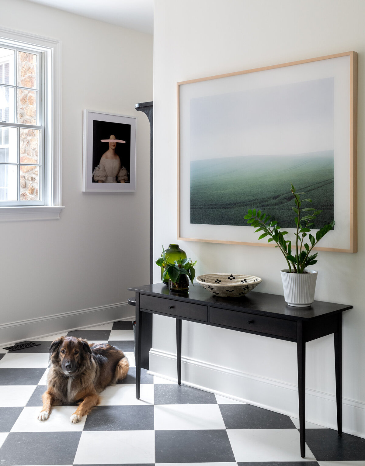 white and black checkered entryway with a dog lying down
