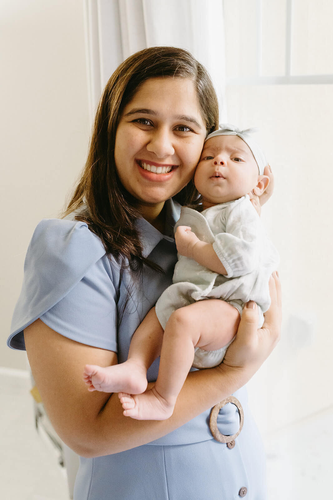 Danville newborn photographer documenting baby yawning in crib with natural light.