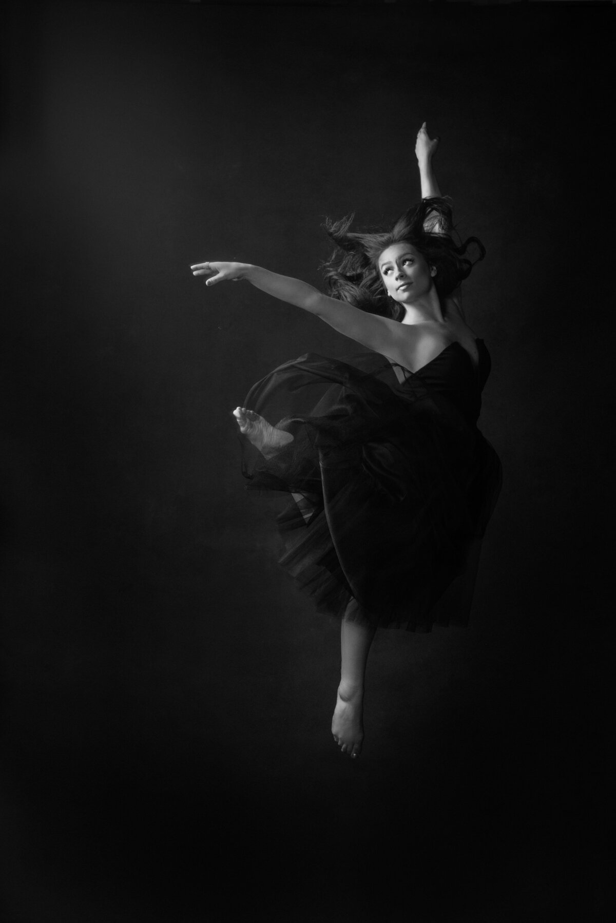 A ballet dancer jumping up.