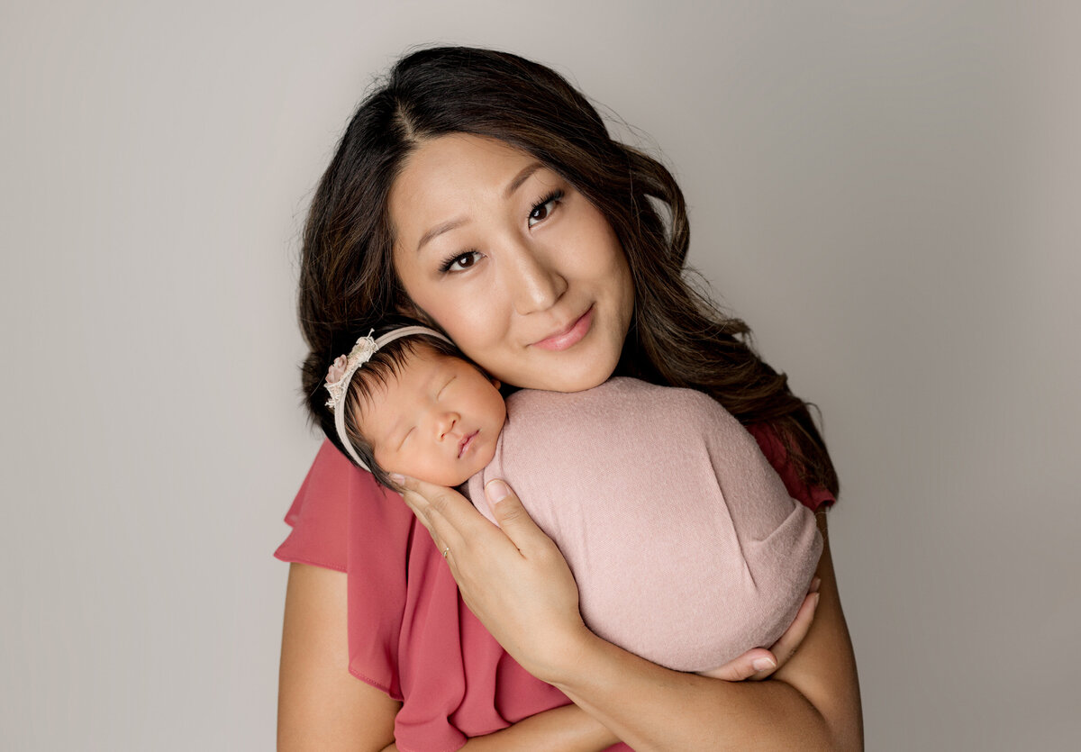 Newborn baby girl posed with mom in studio captured by newborn photographer Candice Berman Photography
