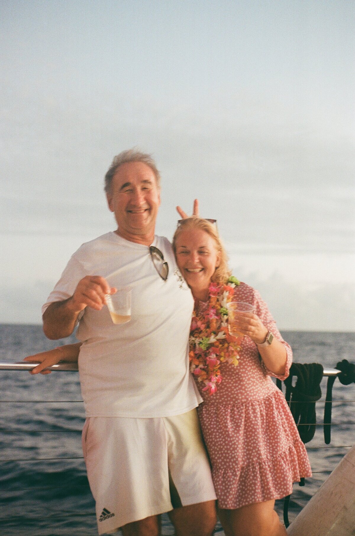Cute couple laughing and goofing around captured on film by Kate Winters Photography, showcasing a candid, joyful moment in an authentic, documentary style.