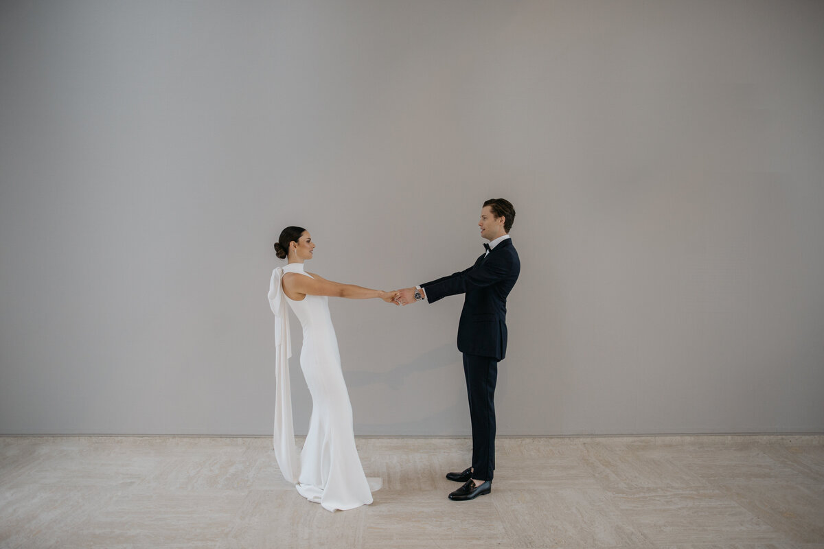 Bride and Groom facing each other holding hands during their elopement photos