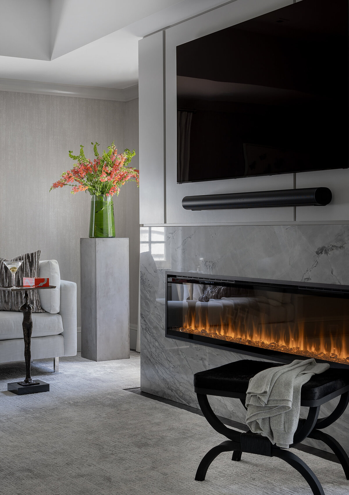 Modern bedroom in Wellesley featuring a sleek fireplace and soft, neutral interior design