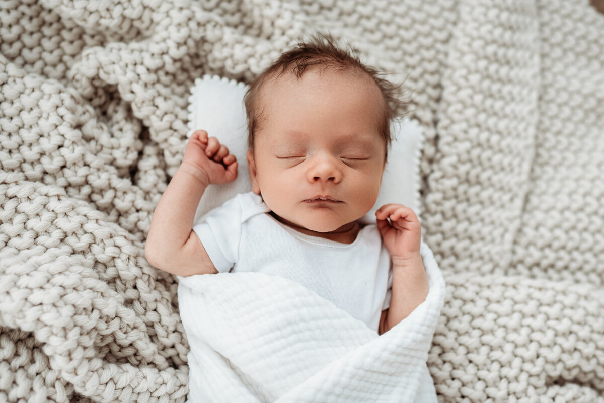 newborn boy on blankets