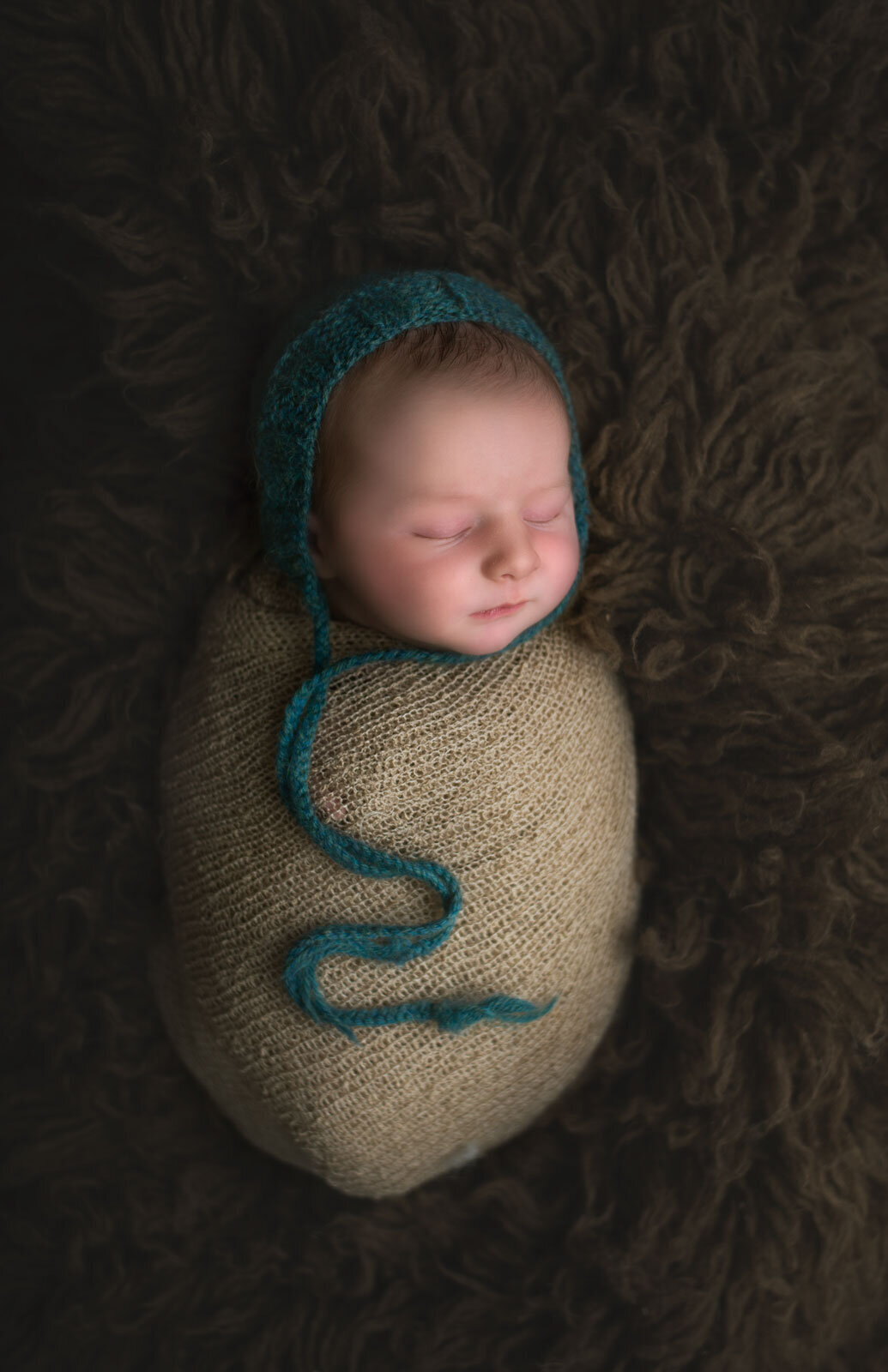 baby swaddled with bonnet by st. louis newborn photographer, sutherland photography
