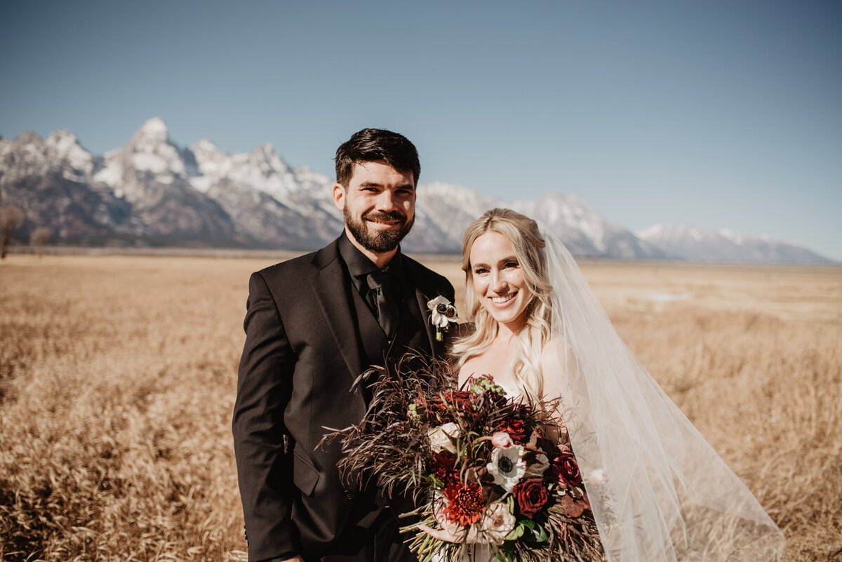 Jackson Hole Photographers capture bride and groom together in front of Tetons
