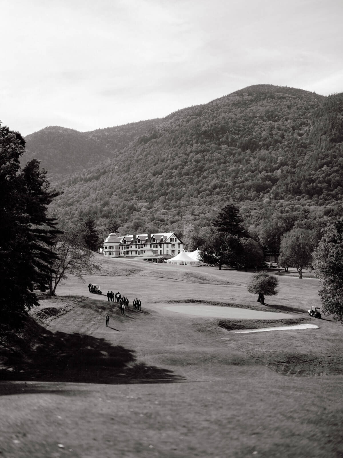 The Ausable Club's golf course, hotel, and the Adirondack Mountains in New York. Image by Jenny Fu Studio.