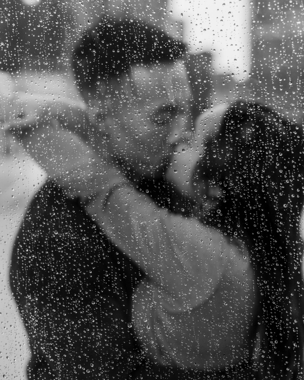blurred-couple-behind-raindrops