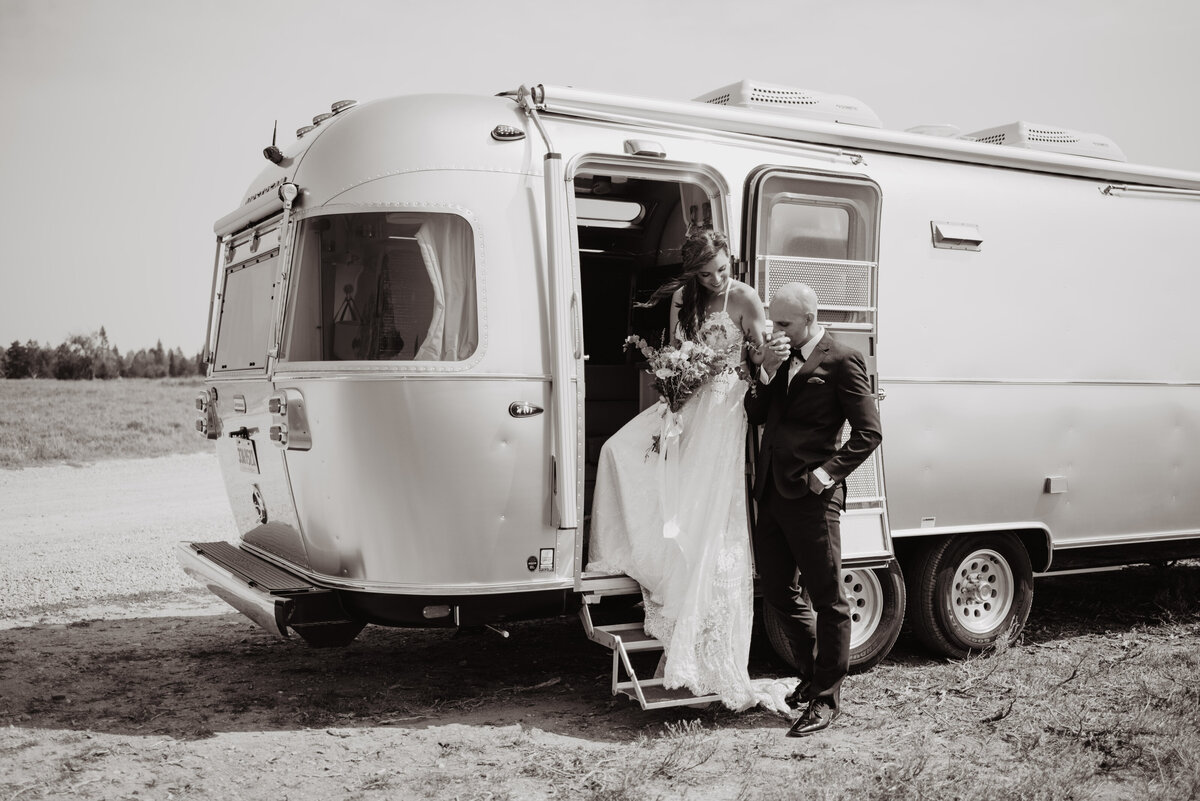 Jackson Hole photographers capture groom helping bride into trailer