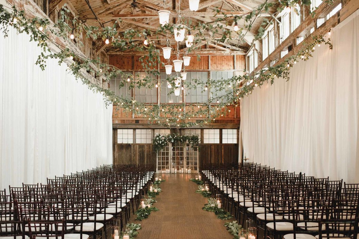 We covered the cafe lights strung above the ceremony space in green vines to cover the space in greenery!