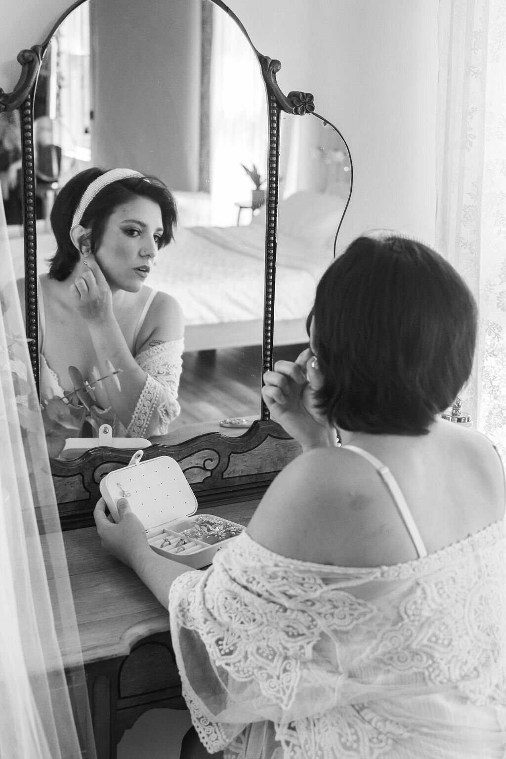 bride sitting in front of boudoir