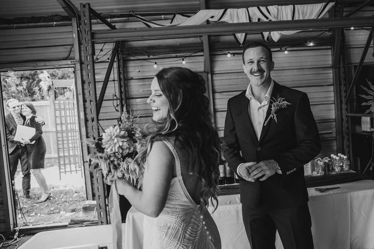 A wedding couple laughing together 