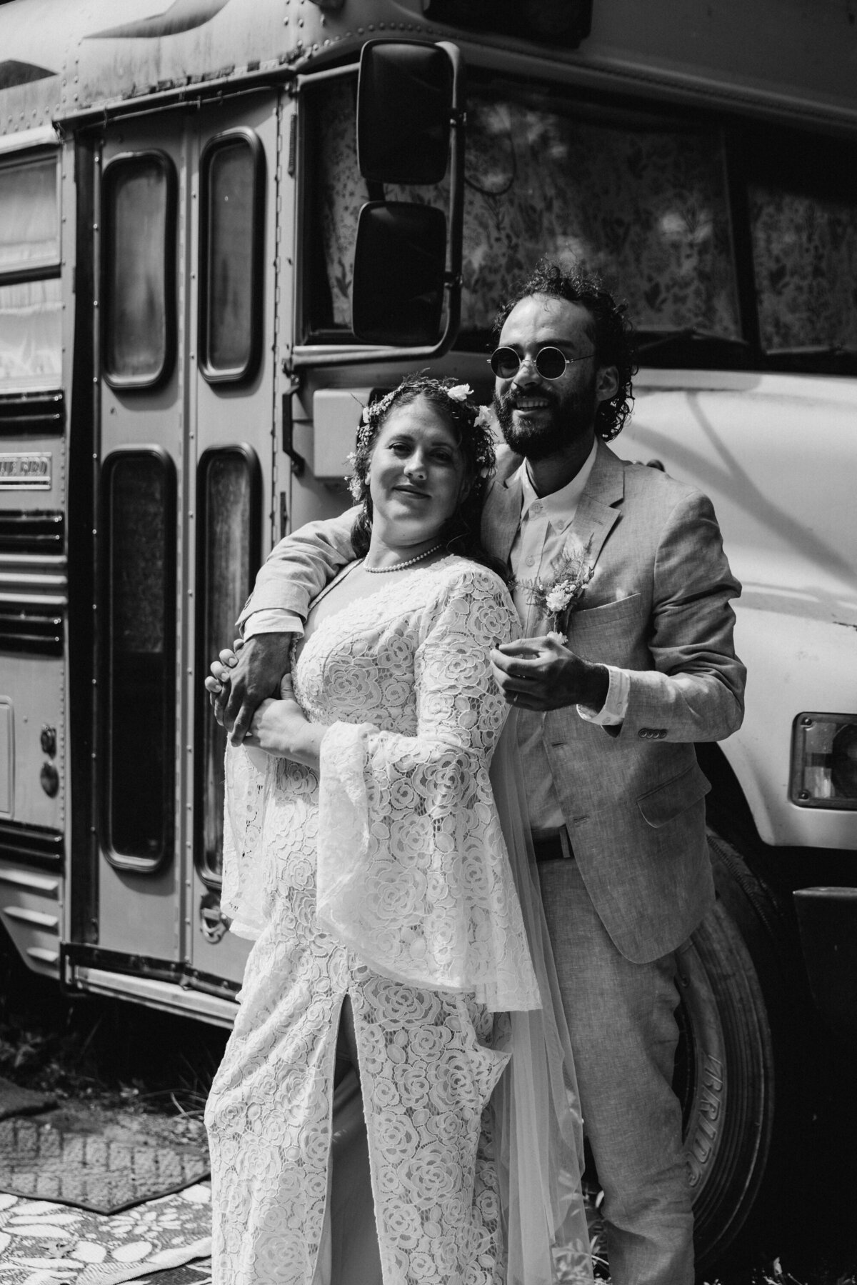 bride and groom smoking a joint in front of their tiny home school bus after eloping