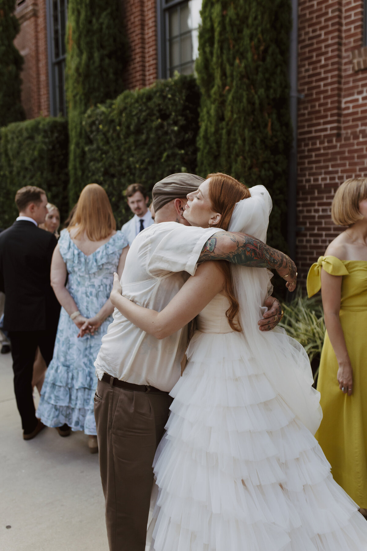 bride giving hugs to family