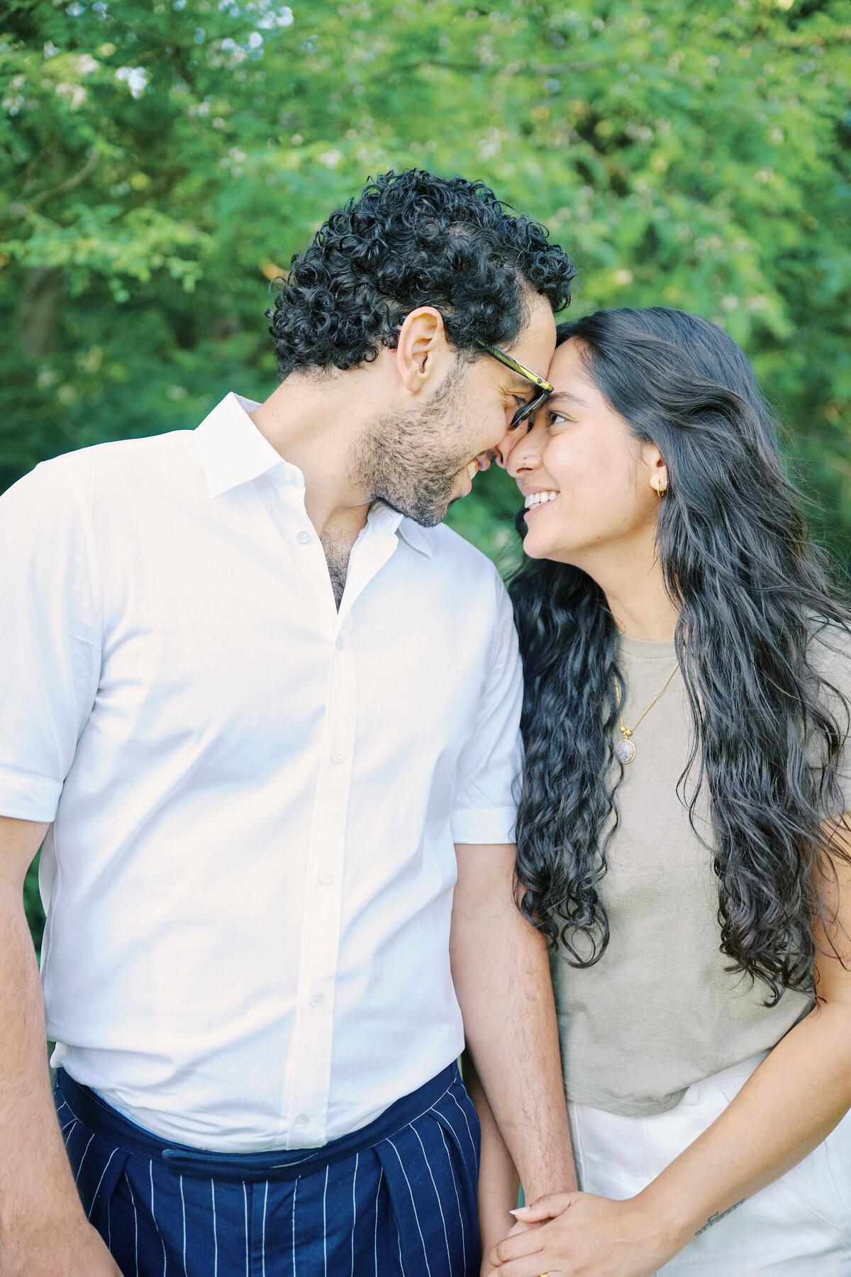 Couple stand face to face smiling after a successful New York City Picnic Proposal.  Photo taken by NYC Proposal Photographer, Corey Lamar Photography