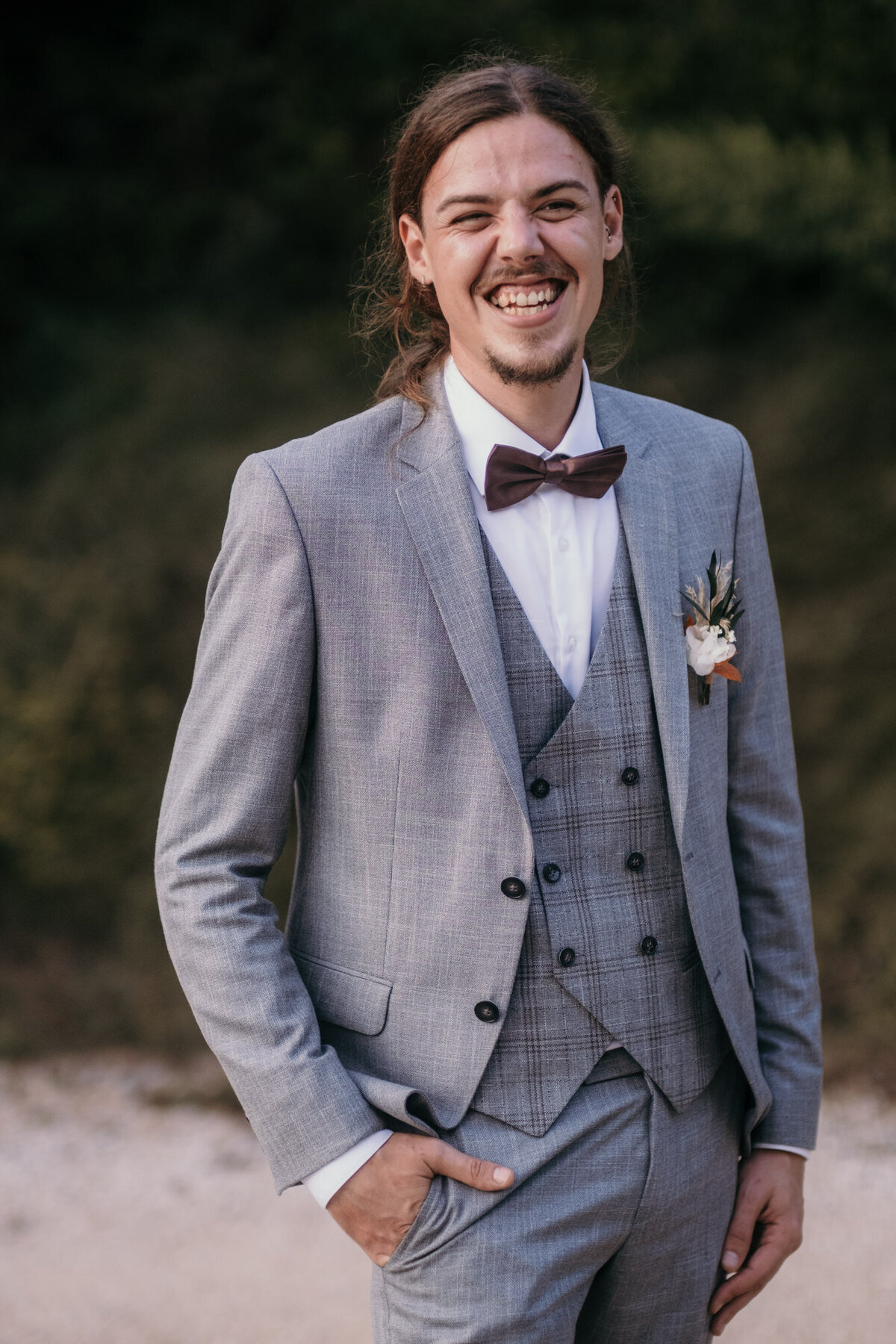 Wedding portrait of the very haapy groom smiling widely.