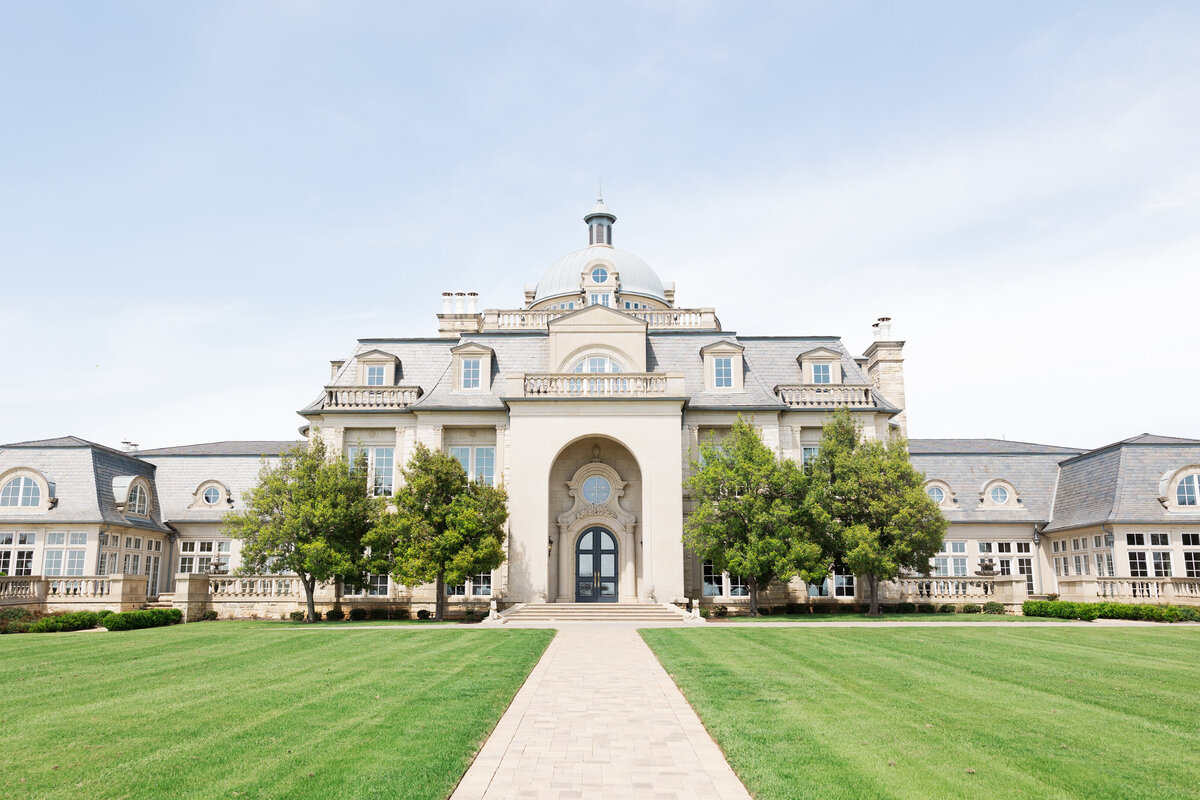 A breathtaking estate venue in Hickory Creek, Texas, captured in a timeless and refined photography style. This image highlights the grand exterior of a luxury wedding location, perfect for couples seeking a classic and romantic setting in the DFW area.