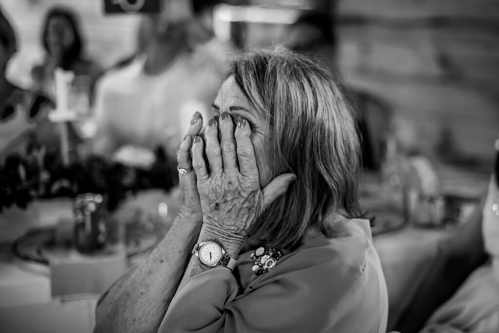 Black and white candid photo of a guest during a Auckland wedding celebration, photographed by Zanthe Vorsatz.
