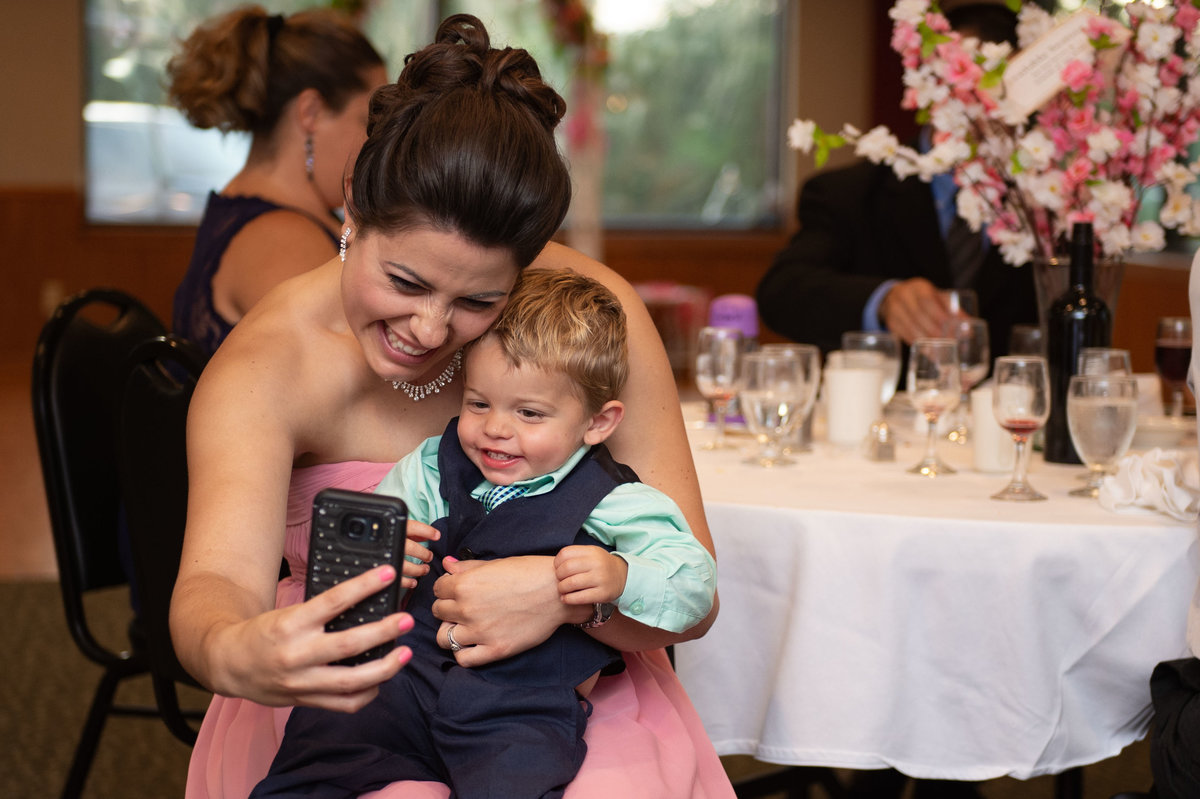 sister of bride does selfie with small boy