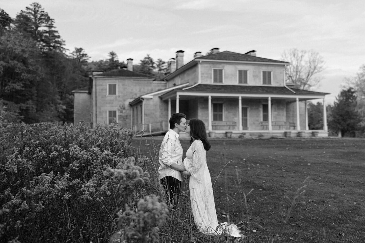 Couple in the grounds of a historical building in Finger Lakes NY for maternity session