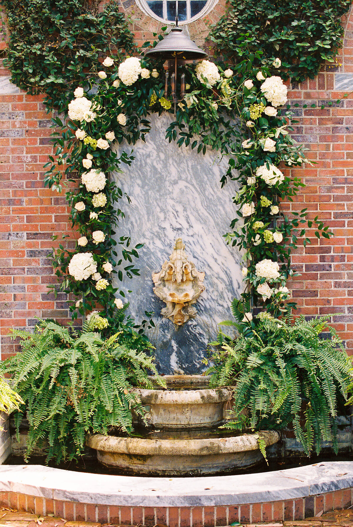 Outdoor fountain decorated with floral installations