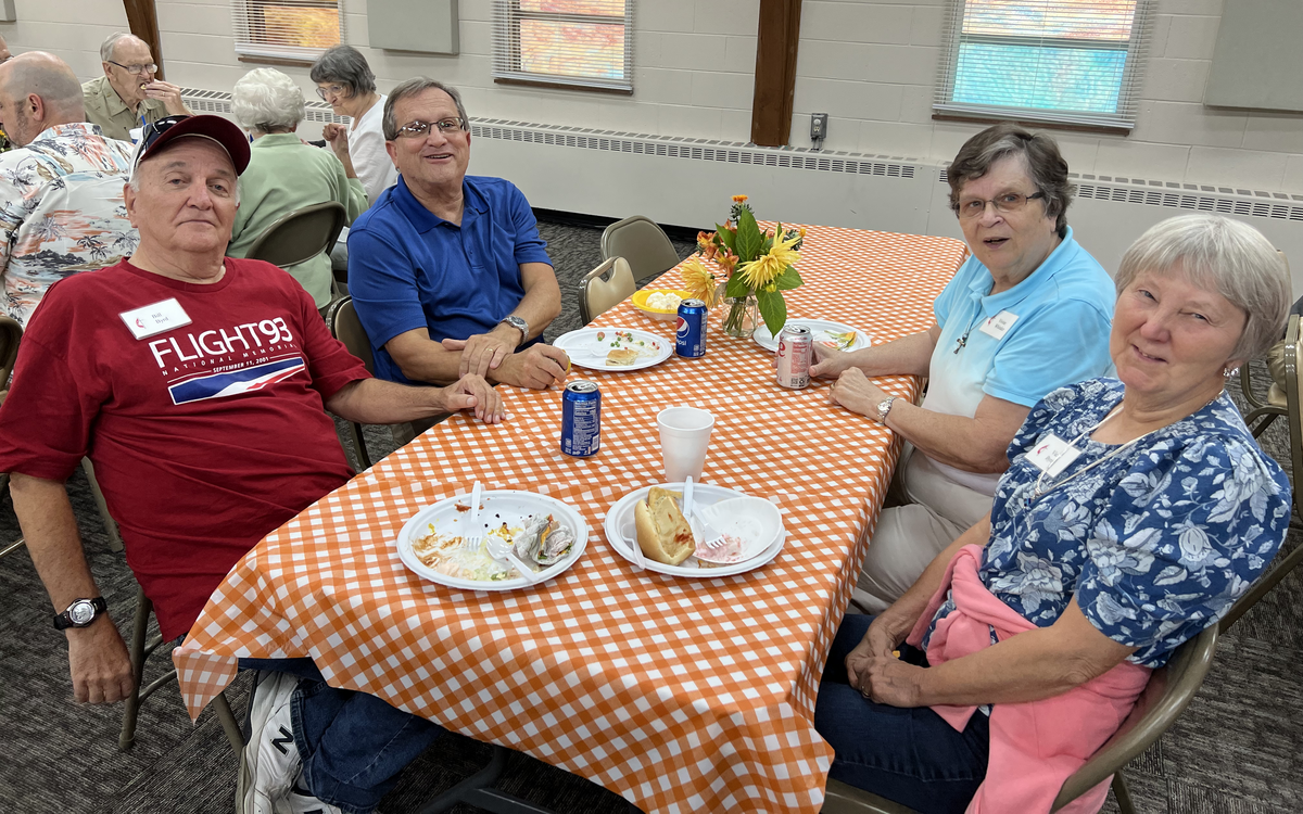 Four adult Bartlett Chapel attendees enjoy fellowship time.